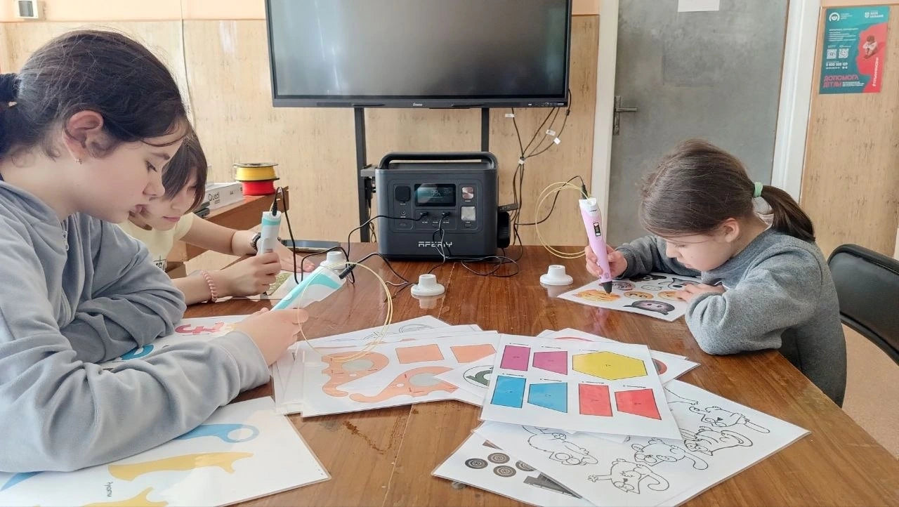 Students adding colorful artwork during an art class